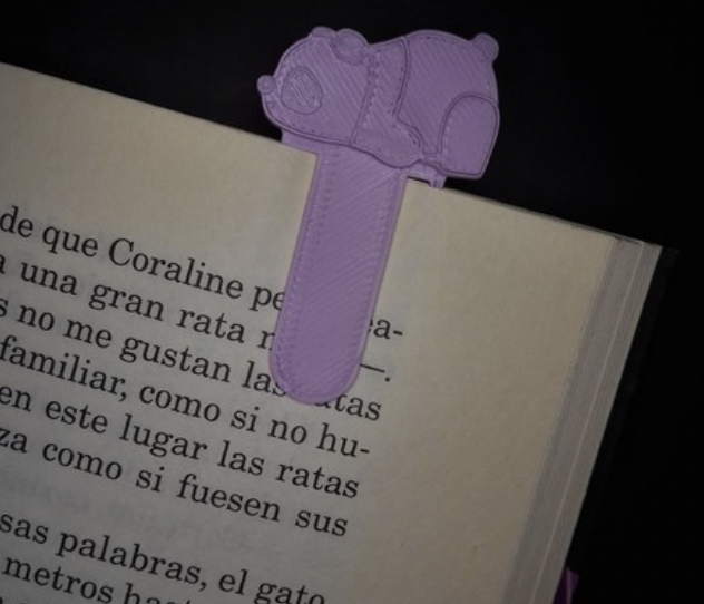 Purple animal bookmark in book