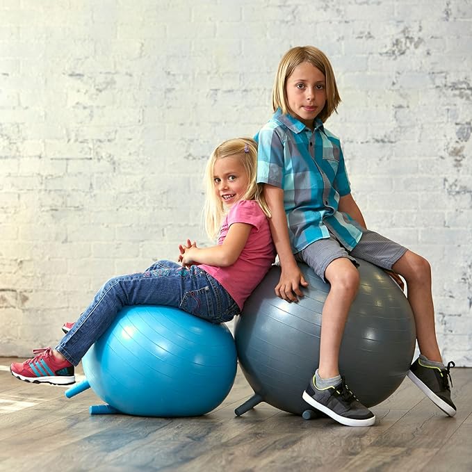 A young boy and young girl sitting on balance balls