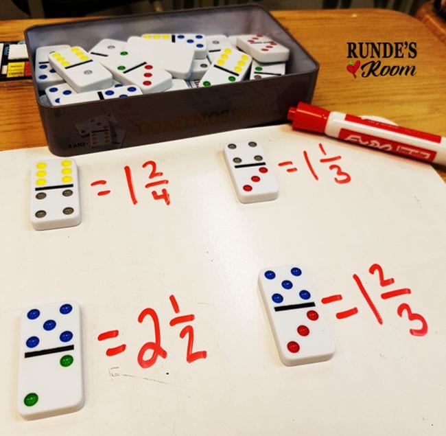Dominos laid out to represent improper fractions, with equivalent mixed numbers written on a whiteboard