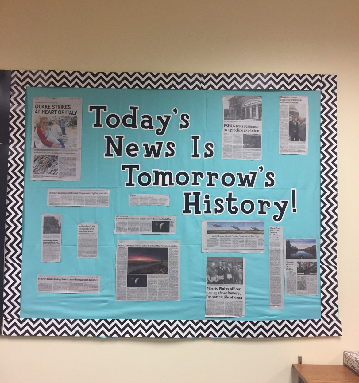 A bulletin board says Today's News is Tomorrow's History and has newspaper clippings on it.