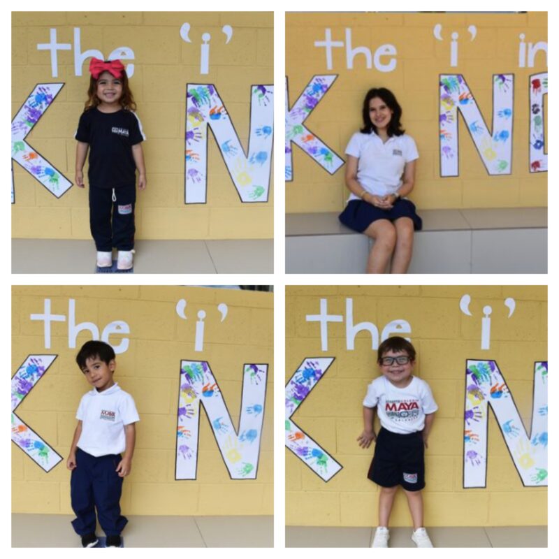 Students sit in front of a wall that reads be the "I" in "kind"