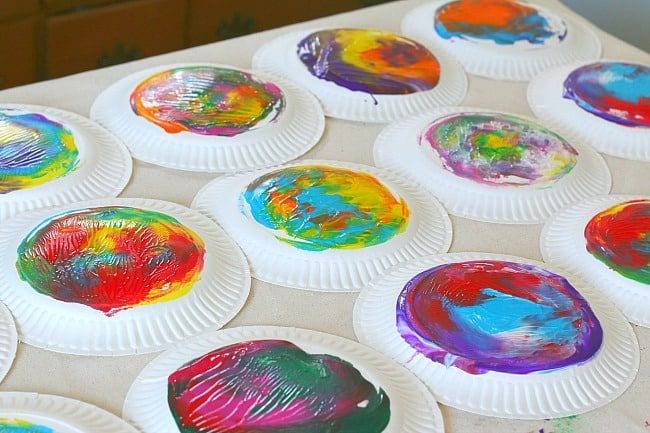 Paper plates painted with a variety of colorful designs