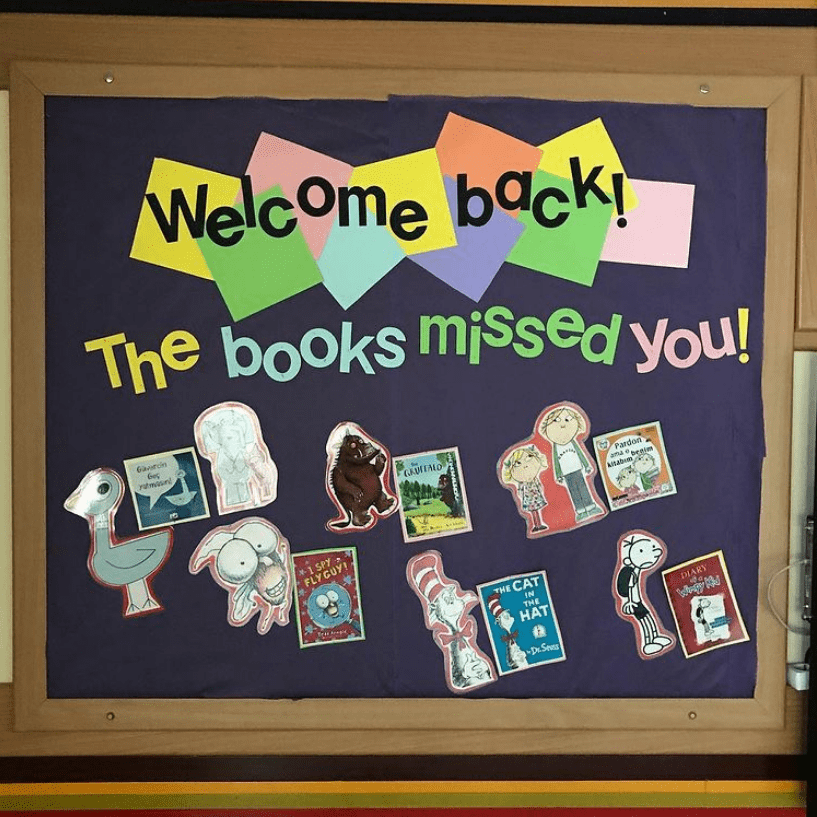 A bulletin board features book covers and says Welcome Back The Books Missed You!