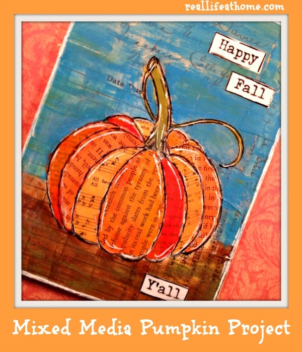 A pumpkin is made from book pages that have been painted orange in this example of fall art projects.