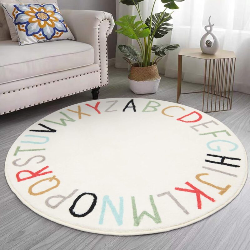 Cream colored circle rug with multi-colored alphabet around the edge