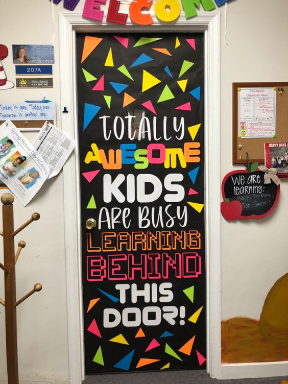A door says totally awesome kids are busy learning behind this door.