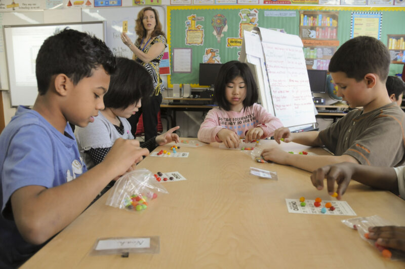 Asian students playing bingo in the classroom