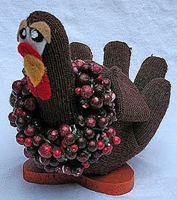 A brown knit glove stuffed and decorated to look like a turkey