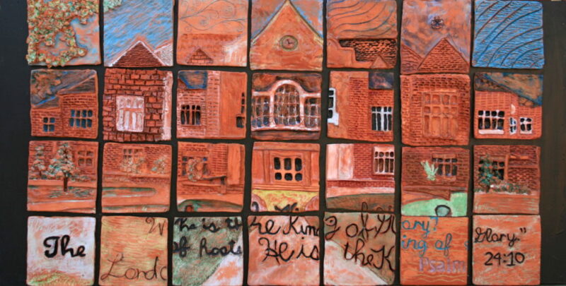 Collaborative art project showing a school building created in individual paper tiles