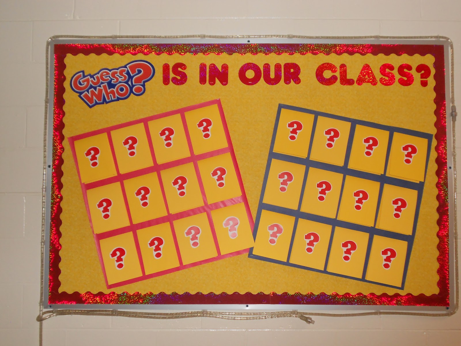 A bulletin board is designed to look like the board game Guess who.