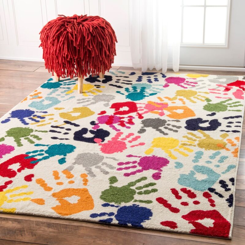 Rug with the design of colorful handprints on it.