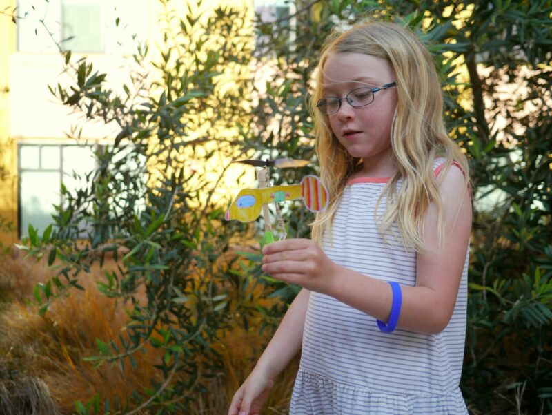 girl holding a helicopter she made 