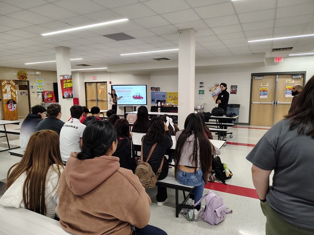 people standing in a cafeteria talking 