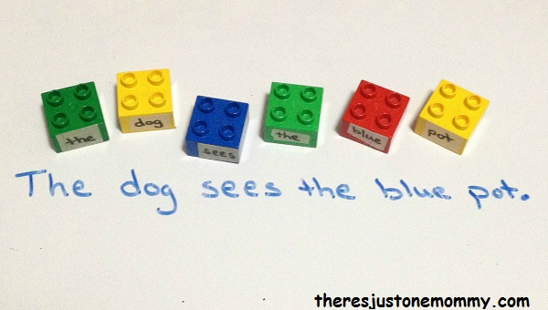 Colorful lego blocks with a word taped to each laid out to form a sentence as an example of grammar games