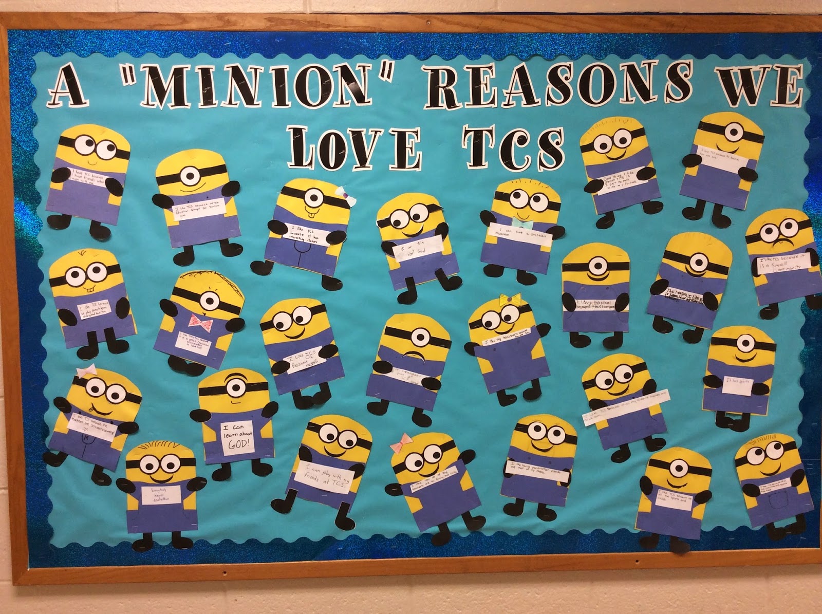 A bulletin board features minions all over it.