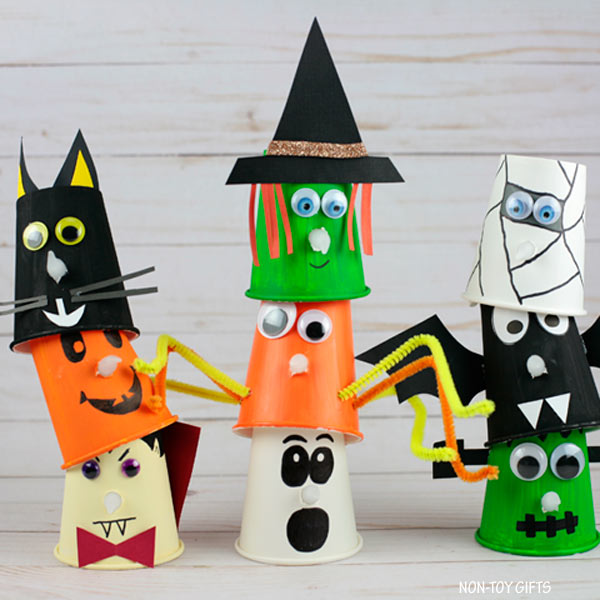 Paper cups colorfully decorated as pumpkins, spiders, witches, ghosts and more as an example of halloween crafts for kids