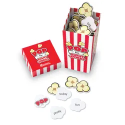 A red striped carton labeled Popcorn with popcorn game pieces inside and in front