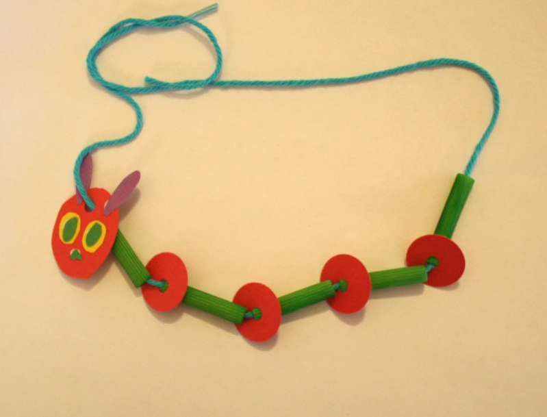 caterpillar necklace made from pasta noodles, paper discs and yarn